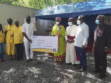 Chief Executive Officer of MTN Ghana Mr. Selorm Adadevoh presenting  the cheque  to the  National COVID Trust Fund